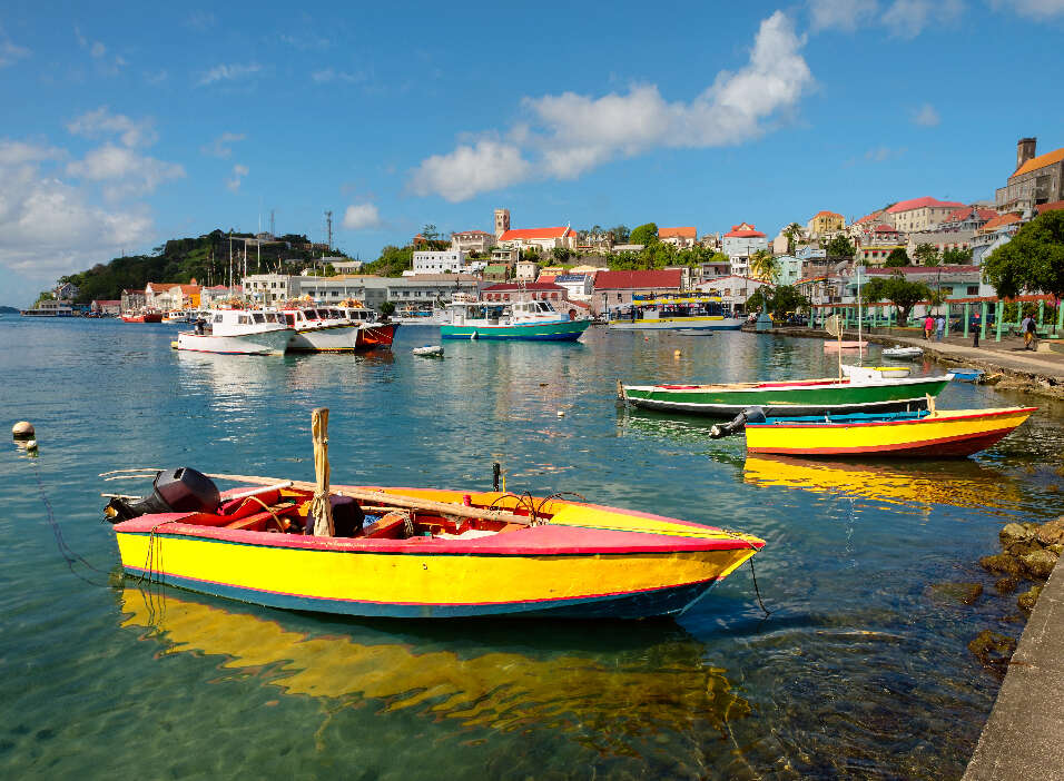 group of boats floating on top of a body of water | Emeraldsuites